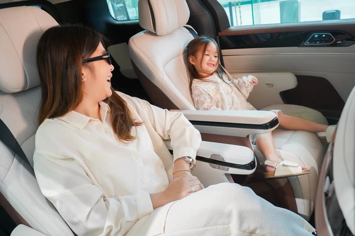 A mother laughing with her daughter in the second row of an eMAX 9