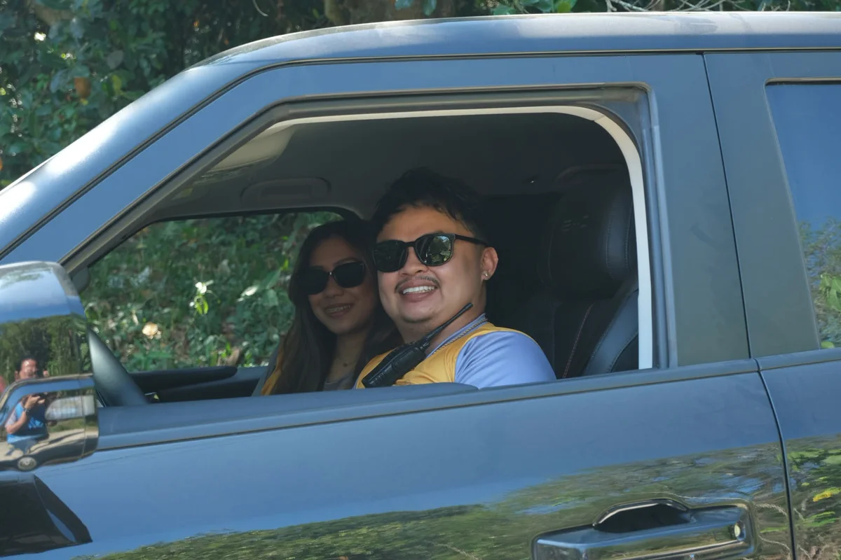 Two women smiling from the window of a Shark 6 on a test drive